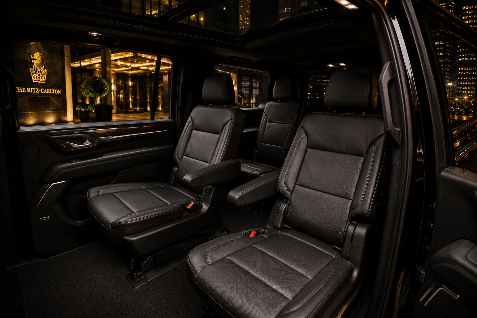 GMC Yukon XL Denali cabin — leather captain's chairs with city views